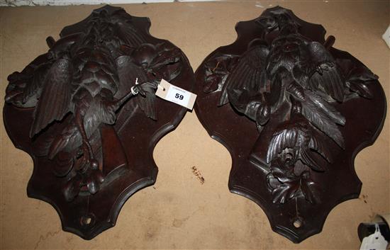 A pair of 19th century Black Forest carved and stained beech game plaques, 23.5in.